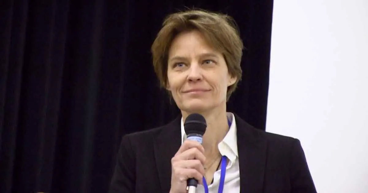 Becka Thompson holding a microphone while delivering her speech at the Ward 12 DFL Convention in Minneapolis on May 3, 2025